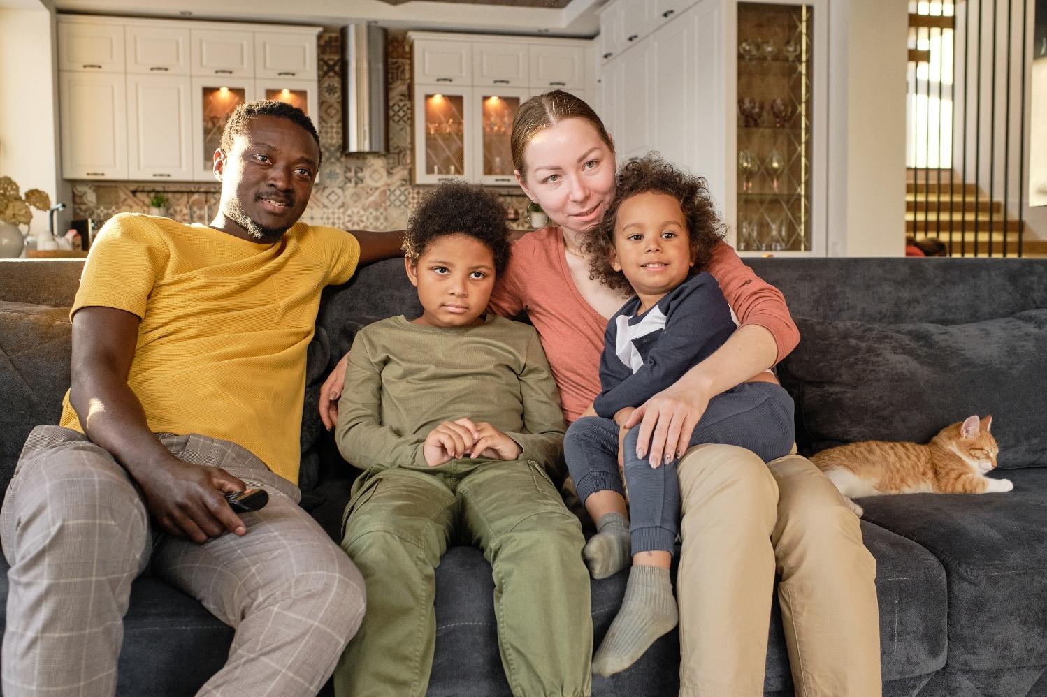 young affectionate family sitting on couch